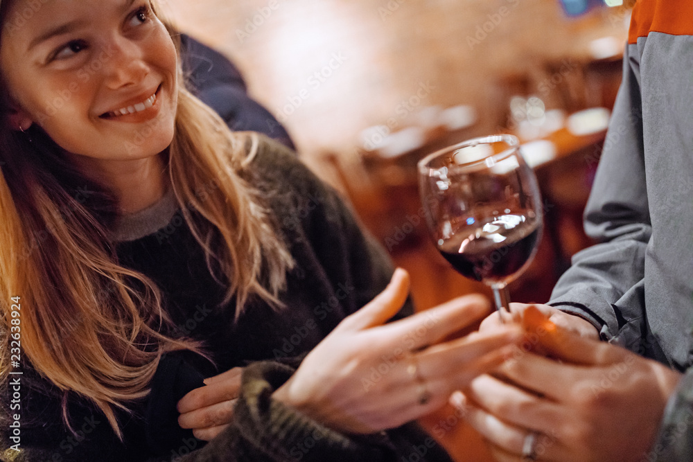 Young woman enjoys a glass of red wine with friends Young woman enjoys a glass of red wine with friends