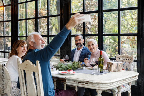 Friends Taking Selfie at Restaurant photo