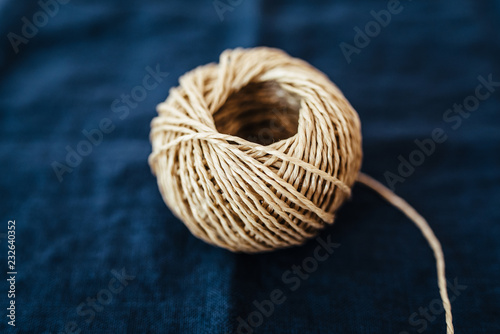 Coil of parcel string on fabric background photo