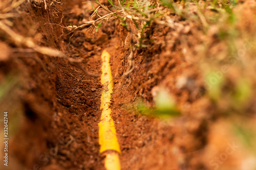 Yellow plastic pipe line for protection fiber optic cable and buried underground