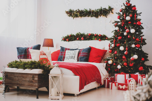 Christmas decorations in the bedroom or studio with bed and pillows