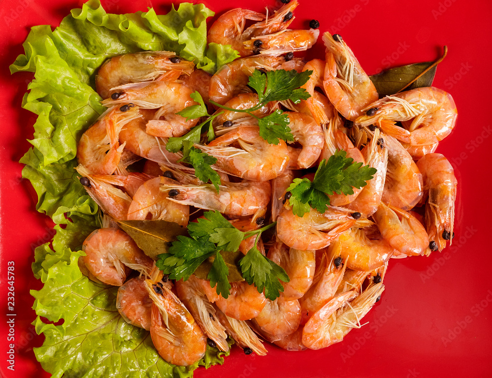 Shrimp and parsley on a red plate. The view from the top. Shrimp and parsley on a red plate. The view from the top.