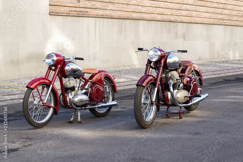 Red vintage motorcycles Jawa 125 and Jawa 500 produced in former Czechoslovakia stand on road