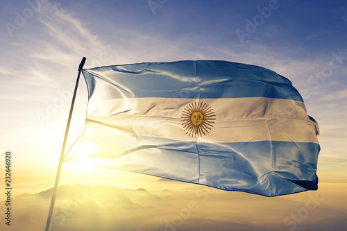 Fotografie Argentina Argentine flag textile cloth fabric waving on the top sunrise mist fog