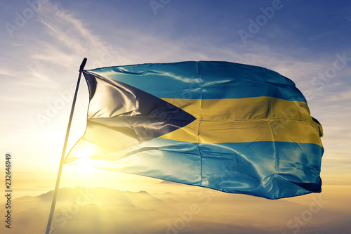 Bahamas Bahamian flag textile cloth fabric waving on the top sunrise mist fog photo