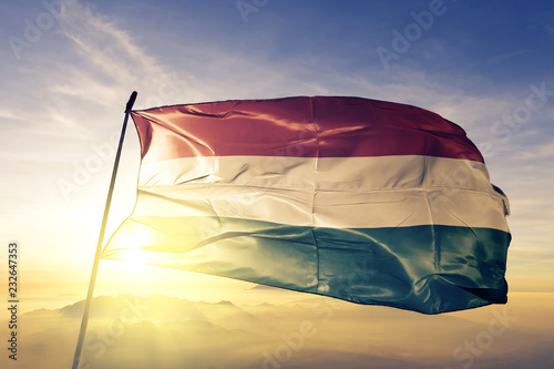 Obraz na plátně Hungary Hungarian flag textile cloth fabric waving on the top sunrise mist fog
