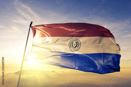 Paraguay Paraguayan flag textile cloth fabric waving on the top sunrise mist fog