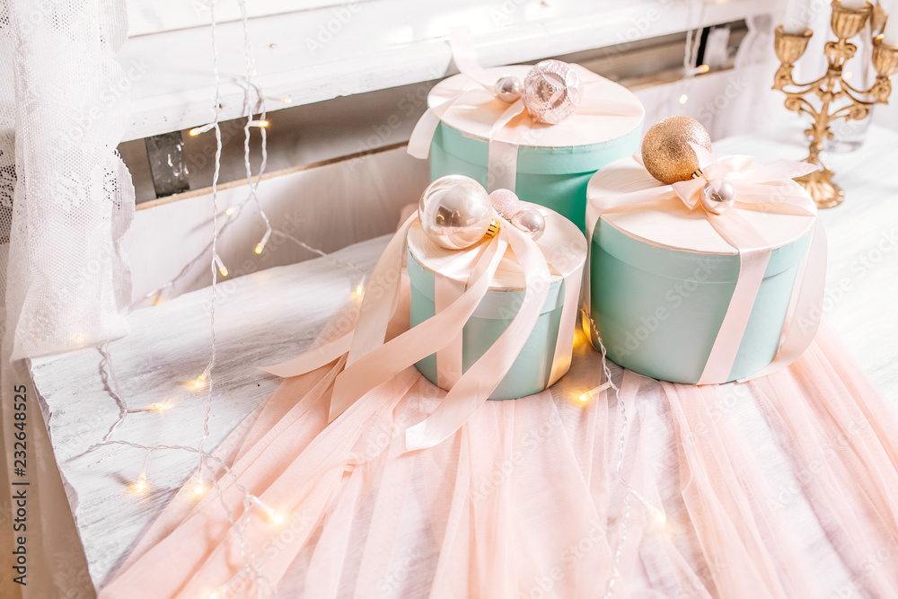 Christmas holiday composition a group of gifts on table on the background of garlands and fireplace. New year 2019. Place for text.