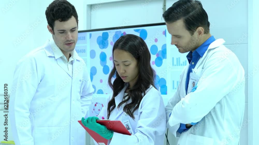 Scientists team meeting and talking in laboratory or medical center. Concept of science, testing development and lab industry. Scientists team meeting and talking in laboratory or medical center. Concept of science, testing development and lab industry.
