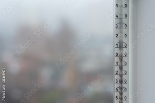  Thermometer of autumn foggy weather. Blurred background of autumn.