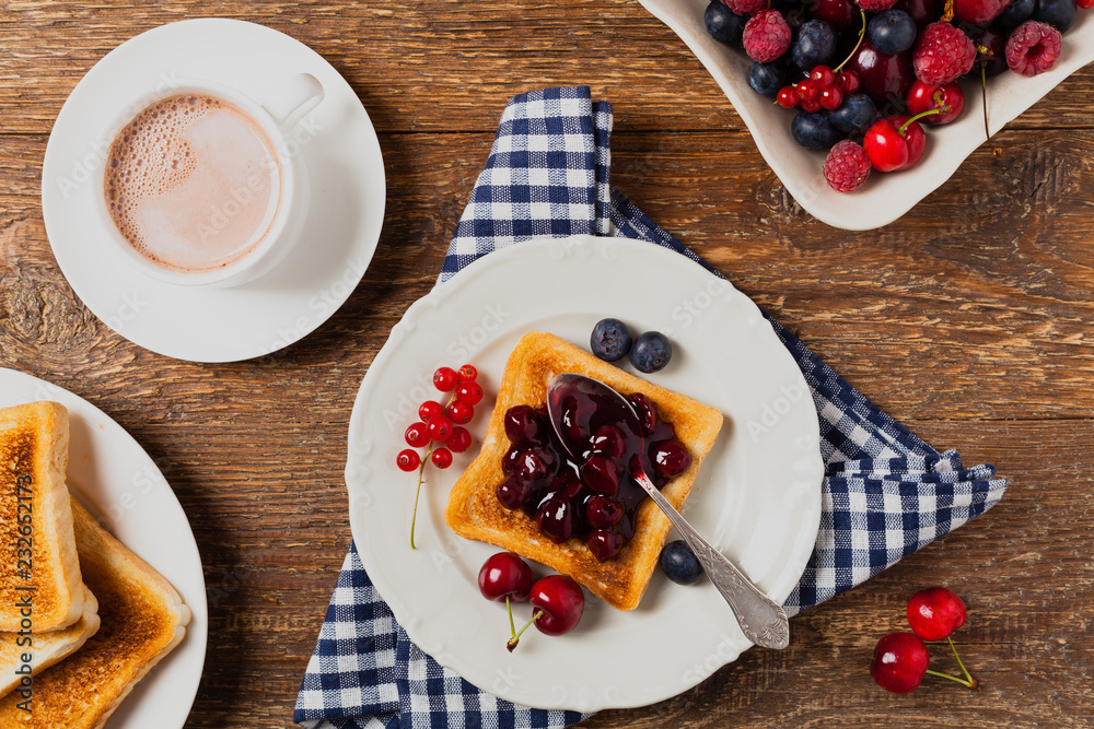 Breakfast. Toasts with cherry or peach jam and fresh fruit.