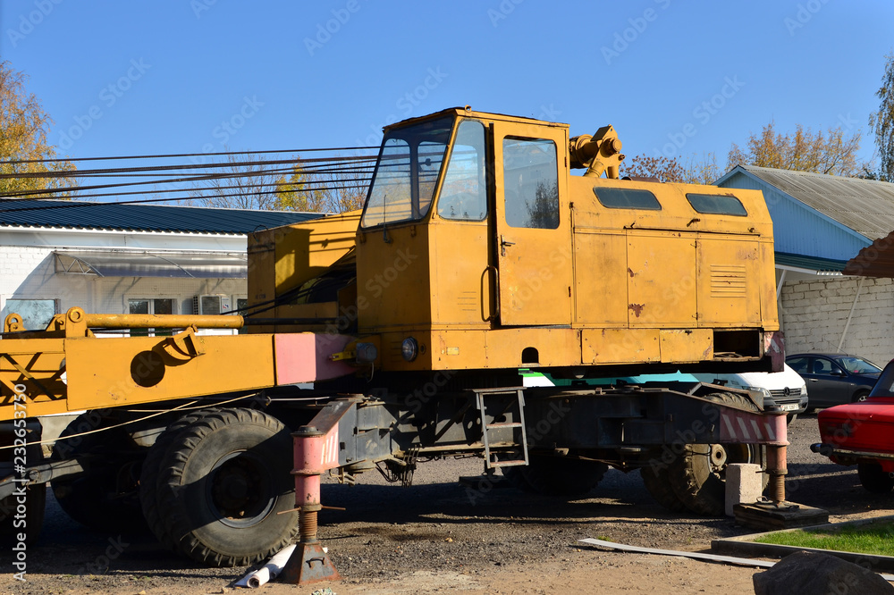 Yellow cab large construction crane on wheels. Special equipment