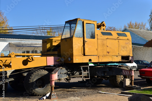 Yellow cab large construction crane on wheels. Special equipment