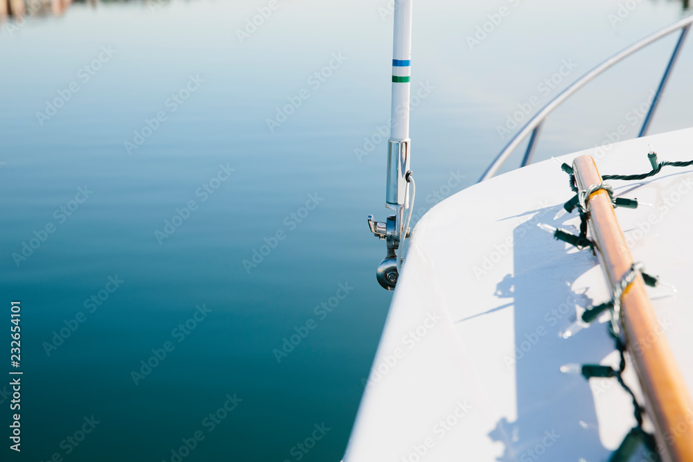 Sailboat sailing over calm clear waters Sailboat sailing over calm clear waters