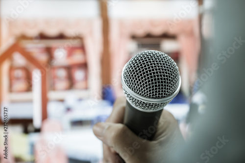 Businesswoman speech or Speaking with microphone in Seminar hall, hand gesturing protesting or belief for explaining in conference room. Speaker tedtalk is vocalized form of communication humans