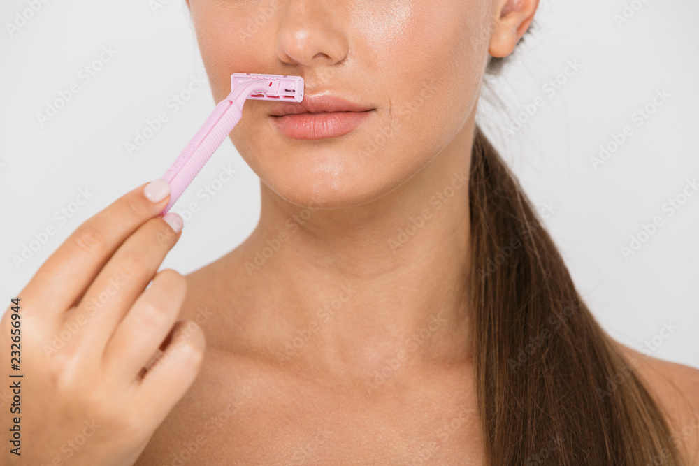 Close up of a young topless woman holding a razor Close up of a young topless woman holding a razor