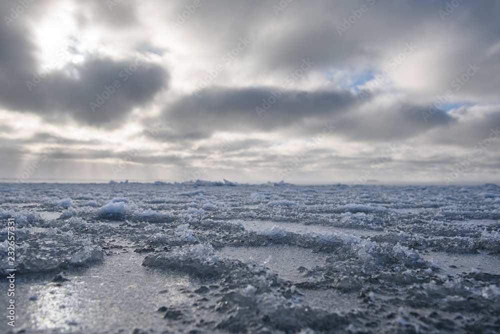 Ice freezes in winter on the surface of a large body of water.
