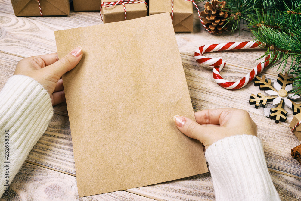 Child write letters and holds them in hands on rustic vintage wooden ...