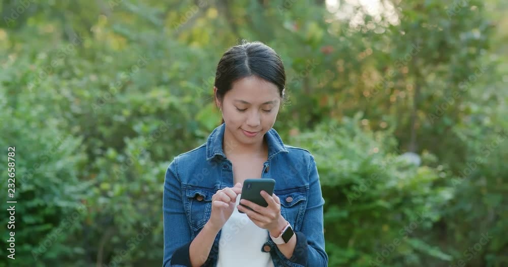 Woman check on smart phone over green background Woman check on smart phone over green background