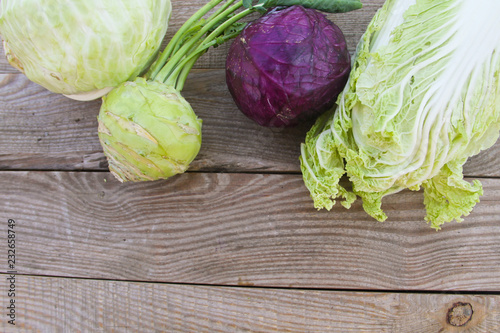 Set of different type of cabbage on rustic wooden table