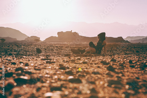 Beautiful young woman in Timna, desert in Israel. Rocks in sunset time. Mystic concept photo