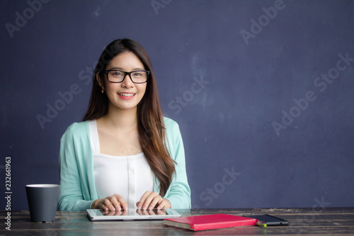 thai china adult office girl glasses white shirt using her tablet.