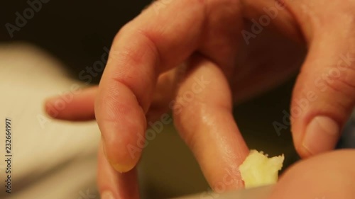 Professional barber takes the pomade on his finger, close-up detailed view