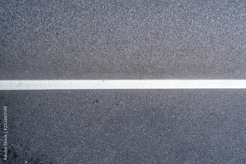 Fototapeta premium Asphalt road with a dividing strip and a place for the inscription