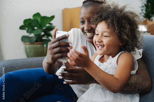 Mother and daughter using phone