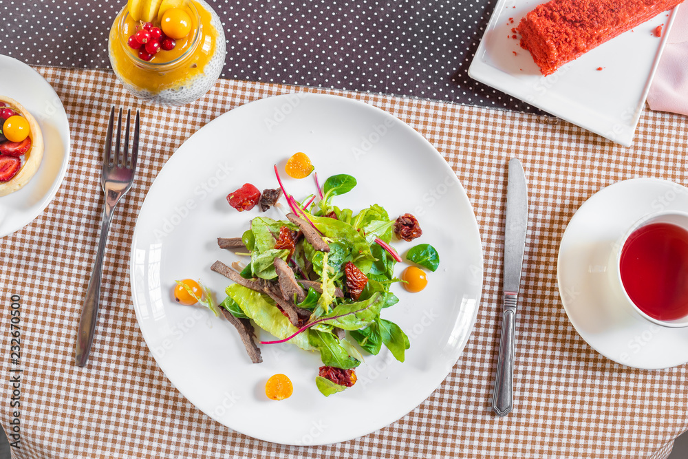 Salad with meat, arugula, algae, tomatoes and greens Salad with meat, arugula, algae, tomatoes and greens