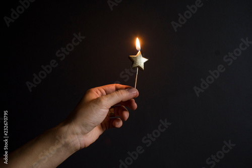 burning star-shaped candle photo