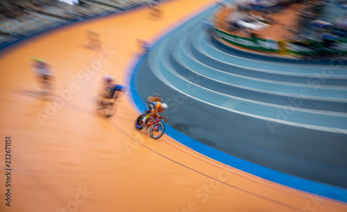 Blurred motion of group of cyclist competing indoor photo
