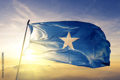 Fotografía Somalia somali flag textile cloth fabric waving on the top sunrise mist fog