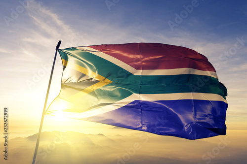 South Africa african flag textile cloth fabric waving on the top sunrise mist fog