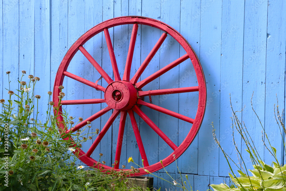 Old Red Wagon Wheel on Blue Barn 
