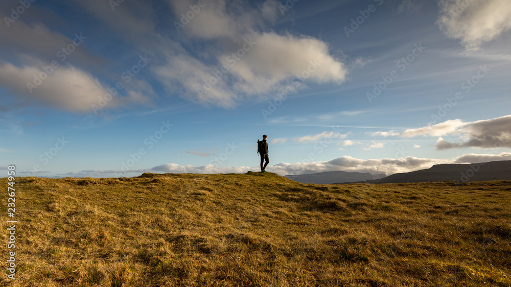 Girl exploring the beautiful highlands in Faroe Islands