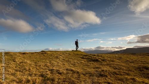 Girl exploring the beautiful highlands in Faroe Islands