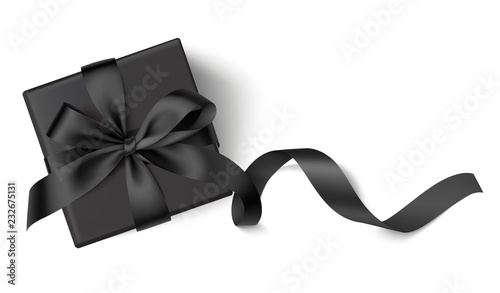 Decorative black gift box with black bow and long ribbon isolated on white background. Top view. Vector illustration. 