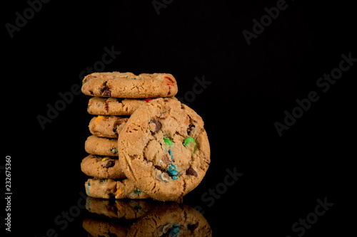 chocolate chip cookies on black background, reflective surface, stacked cookies, Copy space