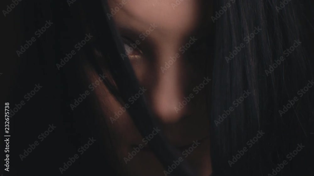Close-up face of a beautiful brunette with blue eyes in Slow Motion Close-up face of a beautiful brunette with blue eyes in Slow Motion