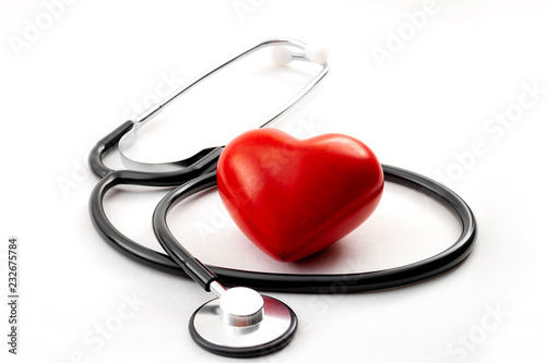 Yearly health check up, disease diagnosis medicine, healthcare and cardiology concept with a red heart and a stethoscope isolated on a hospital white background