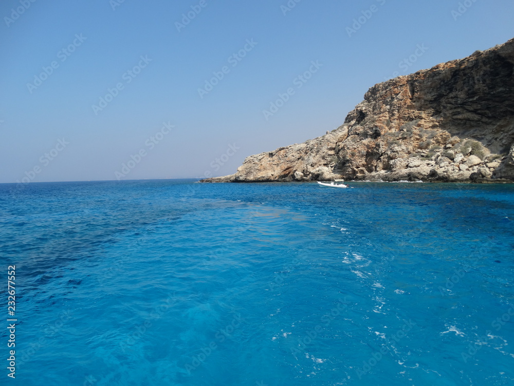 Fototapeta premium the rocky shores of Cyprus on the Mediterranean Sea in the summer during a family holiday and sailing on a yacht in 2018