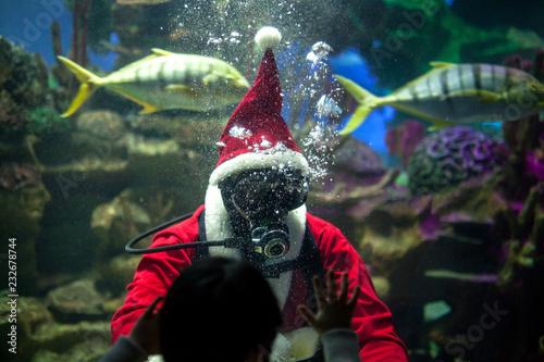 Photography Santa Claus with aqualung under water in aquarium