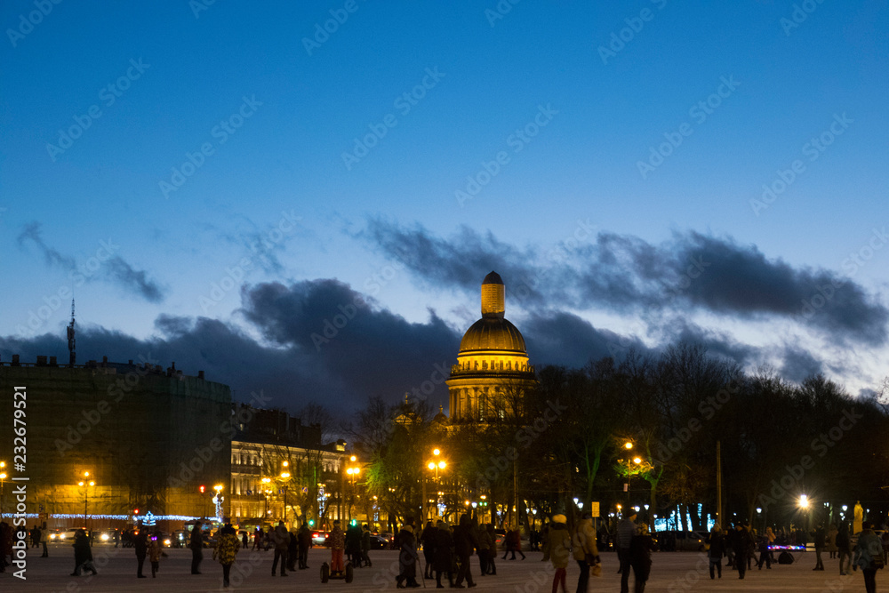 Night city, St. Isaac's Cathedral, people are buzzing along the street.