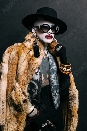 Bizarre fashion studio portrait with extreme makeup photo