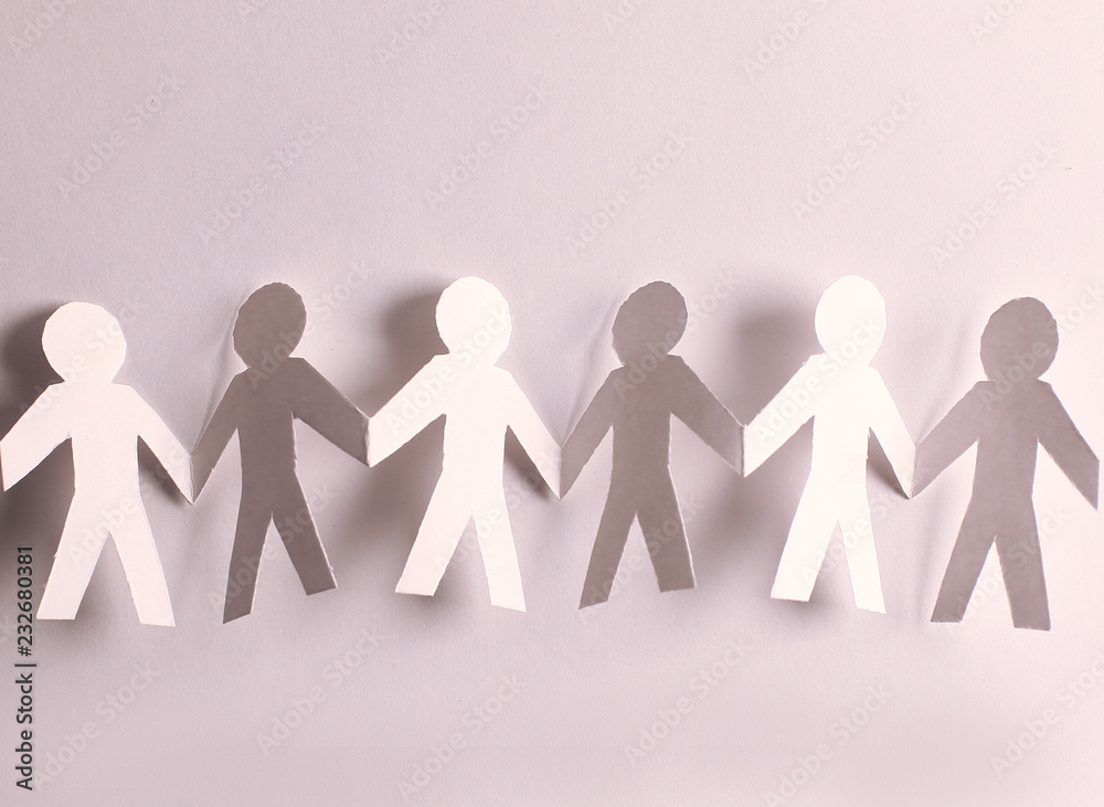 group of paper men holding each other's hands group of paper men holding each other's hands