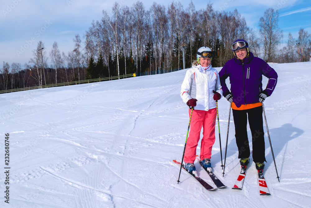 Middle aged couple on ski holiday in mountains.