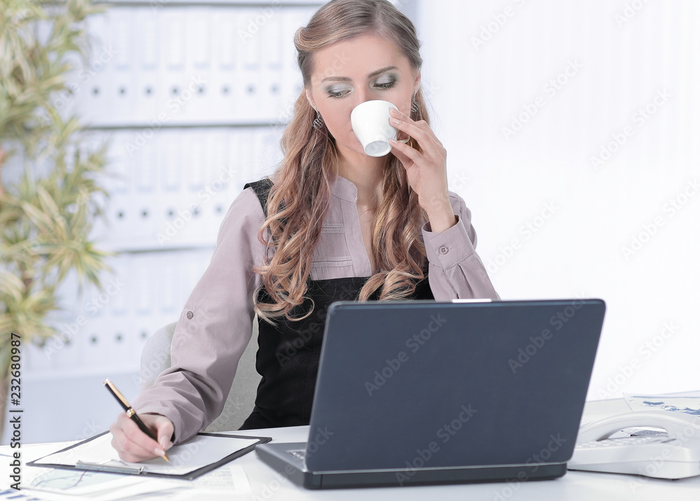 young business woman with Cup of coffee in the workplace young business woman with Cup of coffee in the workplace