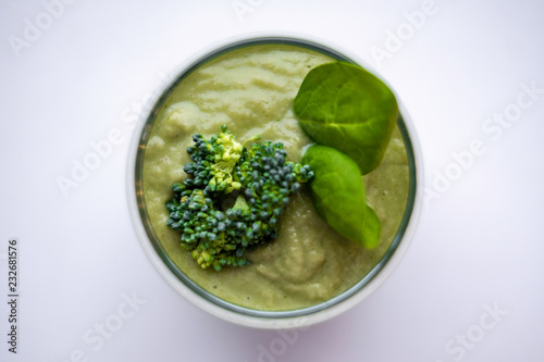 healthy vegetarian smoothie in glass with green smoothie, broccoli and spinach