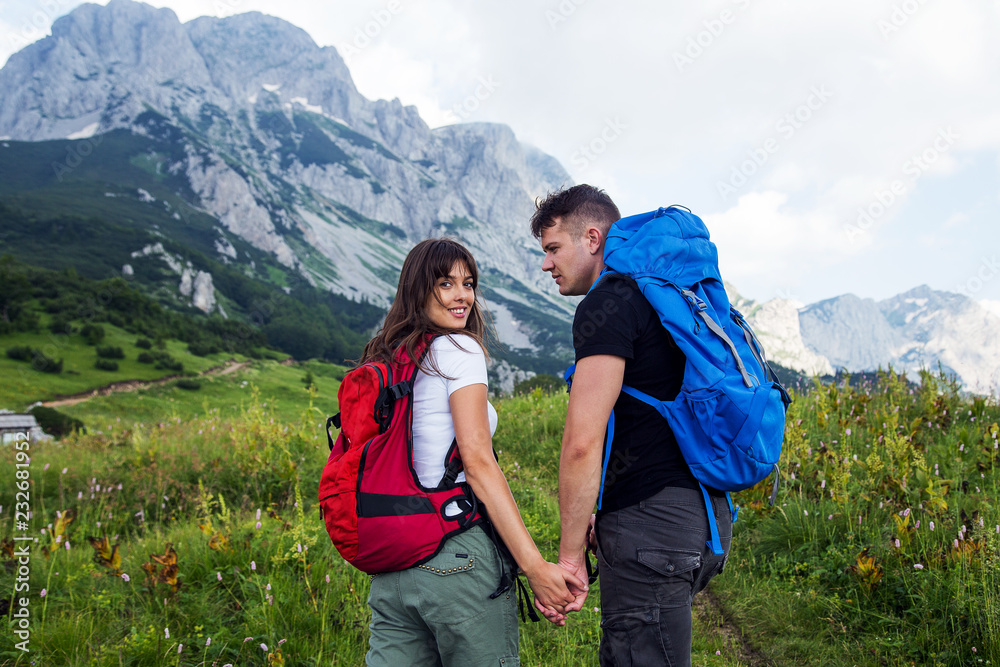 Hiking concept.Young couple enjoying hiking in nature